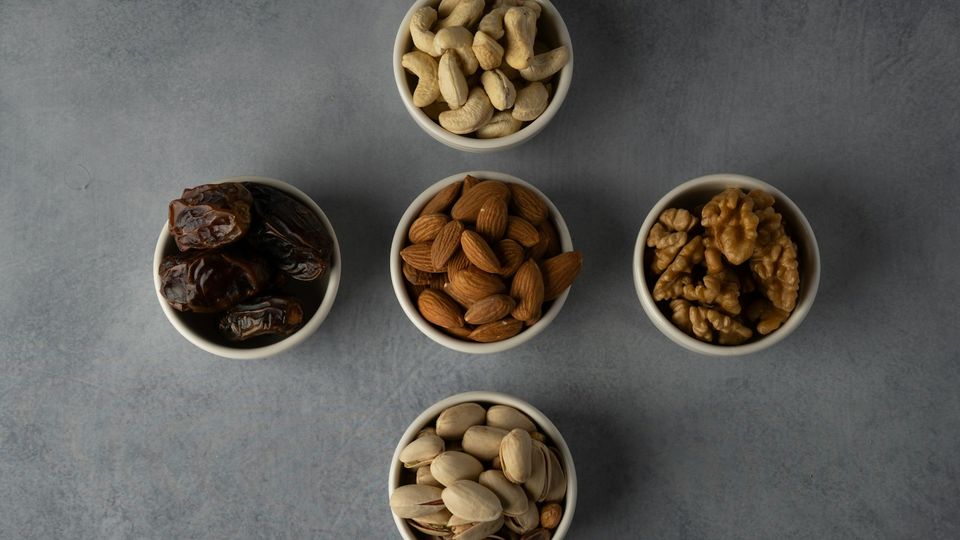 Bowls of dates, almonds, walnuts and pistachios