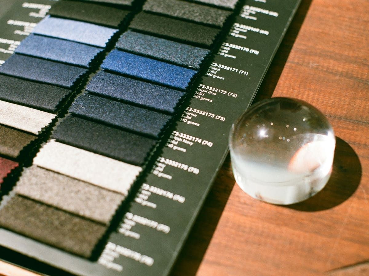 Fabric swatch card next to a glass magnifier