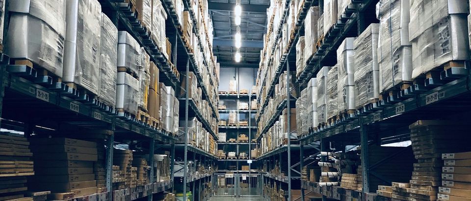 Warehouse aisle with stacked boxes